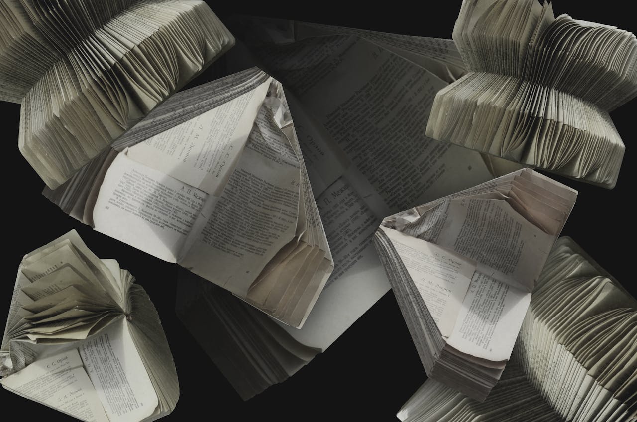 An abstract display of folded vintage books showcasing their pages and textures.
